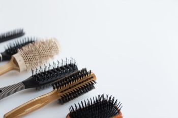 hair tools, beauty and hairdressing concept - different brushes or combs on white background. different hair brushes or combs