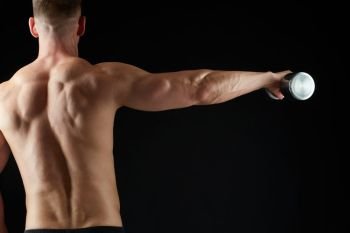 sport, bodybuilding, fitness and people concept - close up of young man with dumbbells flexing muscles over black background. close up of man with dumbbells exercising