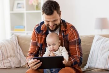 family, parenthood and people concept - happy father and little baby boy with tablet pc computer at home. happy father and baby boy with tablet pc at home