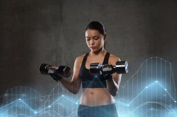 fitness, sport, exercising, training and people concept - young woman flexing muscles with dumbbells in gym. young woman flexing muscles with dumbbells in gym