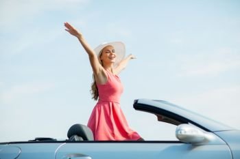 travel, summer holidays, road trip and people concept - happy young woman wearing hat in convertible car enjoying sun. happy young woman in convertible car