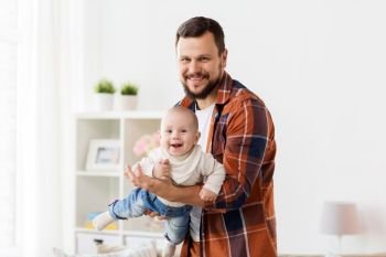 family, parenthood and people concept - happy father playing with little baby boy at home. happy father with little baby boy at home