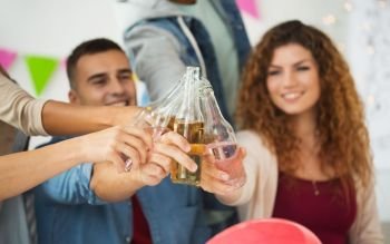 corporate, celebration and holidays concept - happy coworkers clinking bottles with non-alcoholic drinks at office party. happy team with drinks celebrating at office party