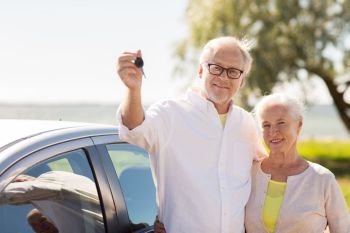 road trip, travel and old people concept - happy senior couple with car key at seaside. happy senior couple with car key at seaside