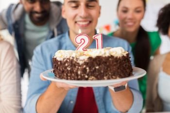 celebration and people concept - close up of happy friends greeting man with cake at twenty first birthday at party. man with cake and friends at birthday party