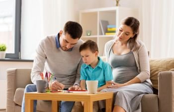family, education and pregnancy concept - father, pregnant mother and little son drawing at home. father, pregnant mother and son drawing at home
