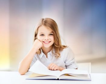 education, people, children and school concept - happy smiling student girl reading book over rose quartz and serenity gradient background. happy smiling student girl reading book