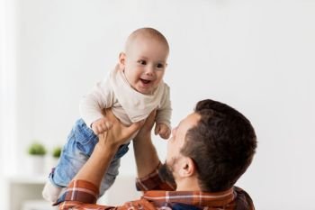 family, childhood, babyhood and people concept - happy little baby boy with father at home. happy little baby boy with father