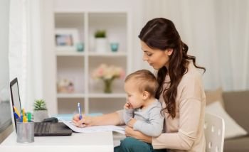 motherhood, multi-tasking, family and people concept - happy mother with baby, papers and laptop working at home. happy mother with baby and papers working at home