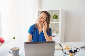 business, technology, communication and people concept - happy middle-aged woman calling on smartphone at office or home. woman calling on smartphone at office or home