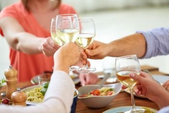 celebration, eating and holidays concept - hands clinking wine glasses. hands clinking wine glasses