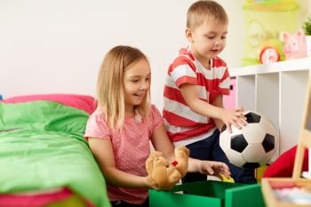childhood, leisure and people concept - happy kids with toys at home. happy kids with toys at home