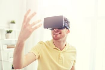 technology, gaming, entertainment and people concept - happy young man with virtual reality headset or 3d glasses playing video game. young man in virtual reality headset or 3d glasses