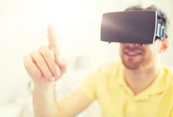3d technology, virtual reality, entertainment and people concept - close up of happy young man with virtual reality headset or 3d glasses playing game at home. young man in virtual reality headset or 3d glasses