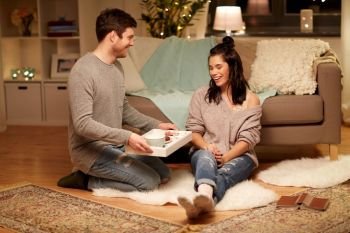 leisure, hygge and people concept - happy couple with food on tray at home. happy couple with food on tray at home