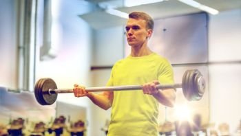 sport, fitness, lifestyle and people concept - man doing exercise with barbell in gym. man doing exercise with barbell in gym