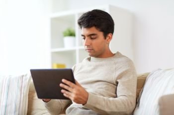 technology, people and lifestyle concept - man with tablet pc computer at home. man with tablet pc at home