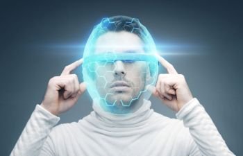 future technology and people concept - man in 3d glasses and virtual helmet over blue background. man in 3d glasses and virtual helmet