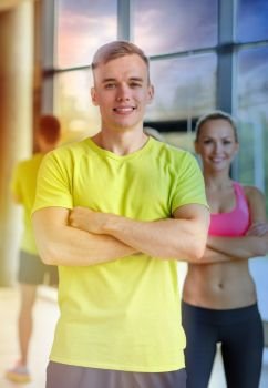 sport, fitness, lifestyle and people concept - smiling man and woman in gym. smiling man and woman in gym