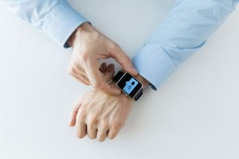 business, technology and people concept - close up of male hands wearing smart watch with social media icons. hands with smart watch and social media icons