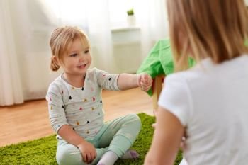 childhood, leisure and family concept - little girls playing rock-paper-scissors game at home. girls playing rock-paper-scissors game at home. girls playing rock-paper-scissors game at home