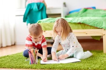 childhood, leisure and people concept - happy kids drawing at home. happy kids drawing at home. happy kids drawing at home