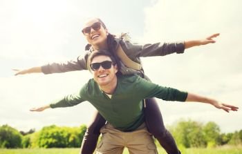 travel, hiking, backpacking, tourism and people concept - happy couple with backpacks having fun and walking along country road outdoors. happy couple with backpacks having fun outdoors. happy couple with backpacks having fun outdoors