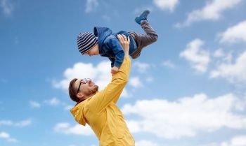 family, childhood and fatherhood concept - happy father and little son playing and having fun outdoors over blue sky and clouds background. father with son playing and having fun outdoors. father with son playing and having fun outdoors