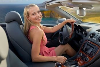 travel, road trip and people concept - happy young woman driving convertible car over bixby creek bridge on big sur coast of california background. woman driving convertible car on big sur coast. woman driving convertible car on big sur coast