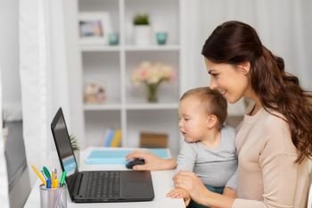 motherhood, multi-tasking, family and people concept - happy mother with baby and laptop working at home. happy mother with baby and laptop working at home. happy mother with baby and laptop working at home