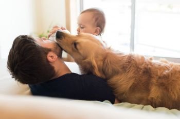 Family having fun with a feeding bottle - Father, baby and dog!  