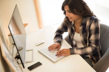 Female programmer working on desktop computer