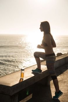 Fitness woman doing exercices on summer sunset