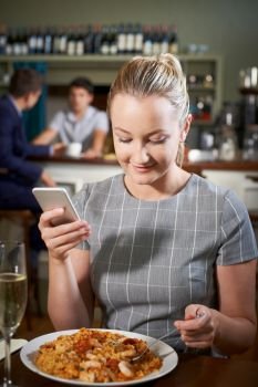 Food Blogger Posting Online Review Of Restaurant Meal Using Mobile Phone