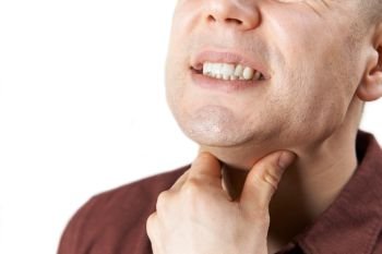 Close Up Of Man Suffering With Sore Throat