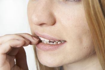 Close Up Of Nervous Woman Biting Nails