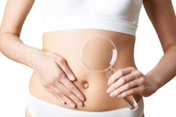 Close Up Of Woman Wearing Underwear Holding Magnifying Glass And Touching Stomach