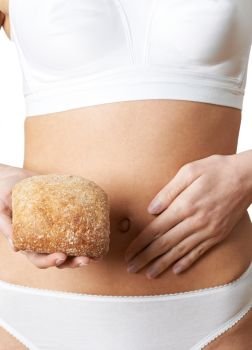 Close Up Of Woman Wearing Underwear Holding Bread Roll And Touching Stomach