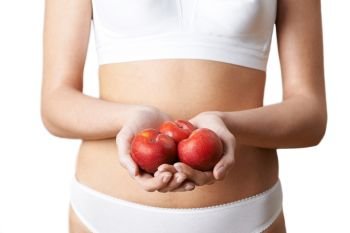 Close Up Of Woman In Underwear Holding Fresh Plums