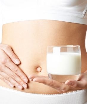 Close Up Of Woman Wearing Underwear Drinking Glass Of Fresh Milk And Touching Stomach