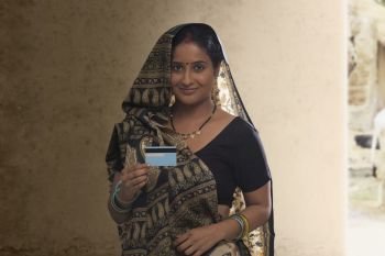 Portrait of rural woman holding credit card