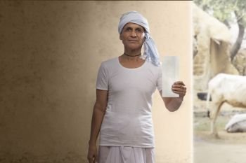 Portrait of  Indian farmer showing a bank cheque