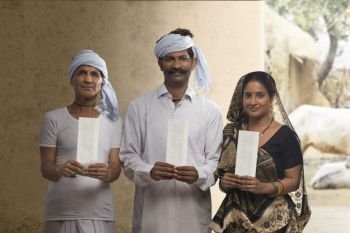 Indian rural farmer family holding bank cheque