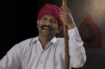 Portrait of farmer wearing turban holding stick