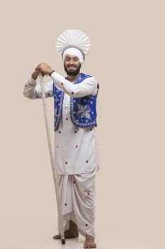 Standing Of Sikh man with Stick