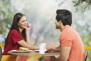  Young couple having morning break at table 