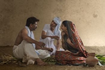 Two farmer talking with rural woman