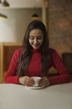 Young woman having cup of coffee