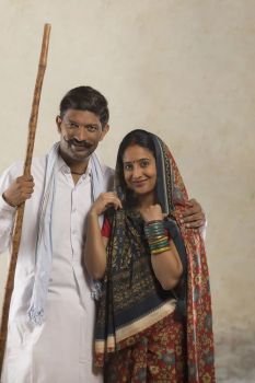 Portrait of Indian rural couple holding stick