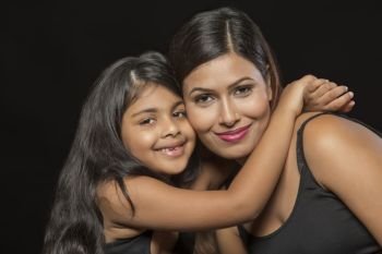 Portrait of smiling mother and daughter embracing